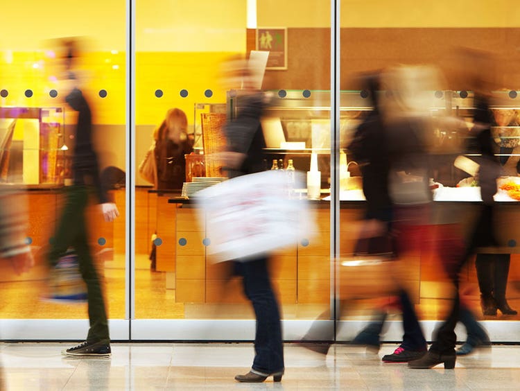 Blurred photo of people browsing salad bar