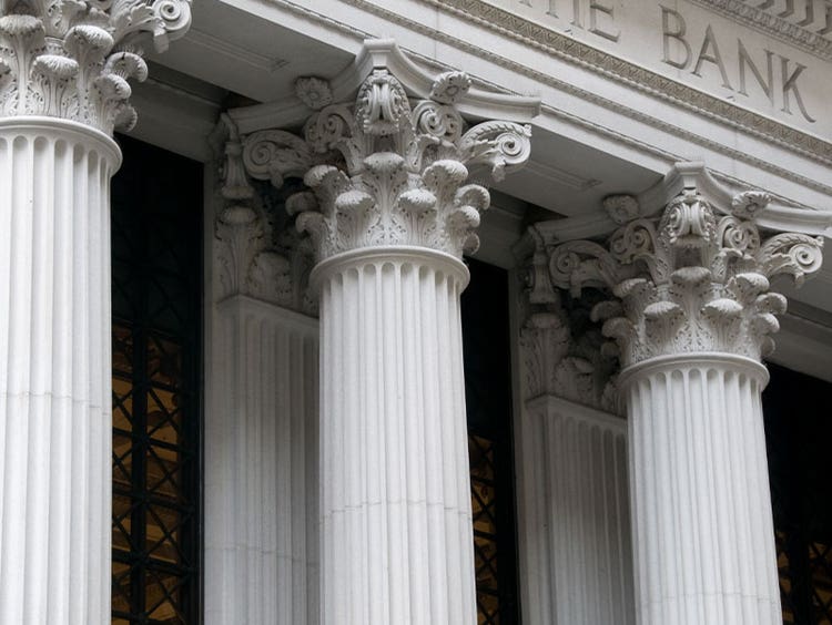 Exterior view of bank, columns standing strong
